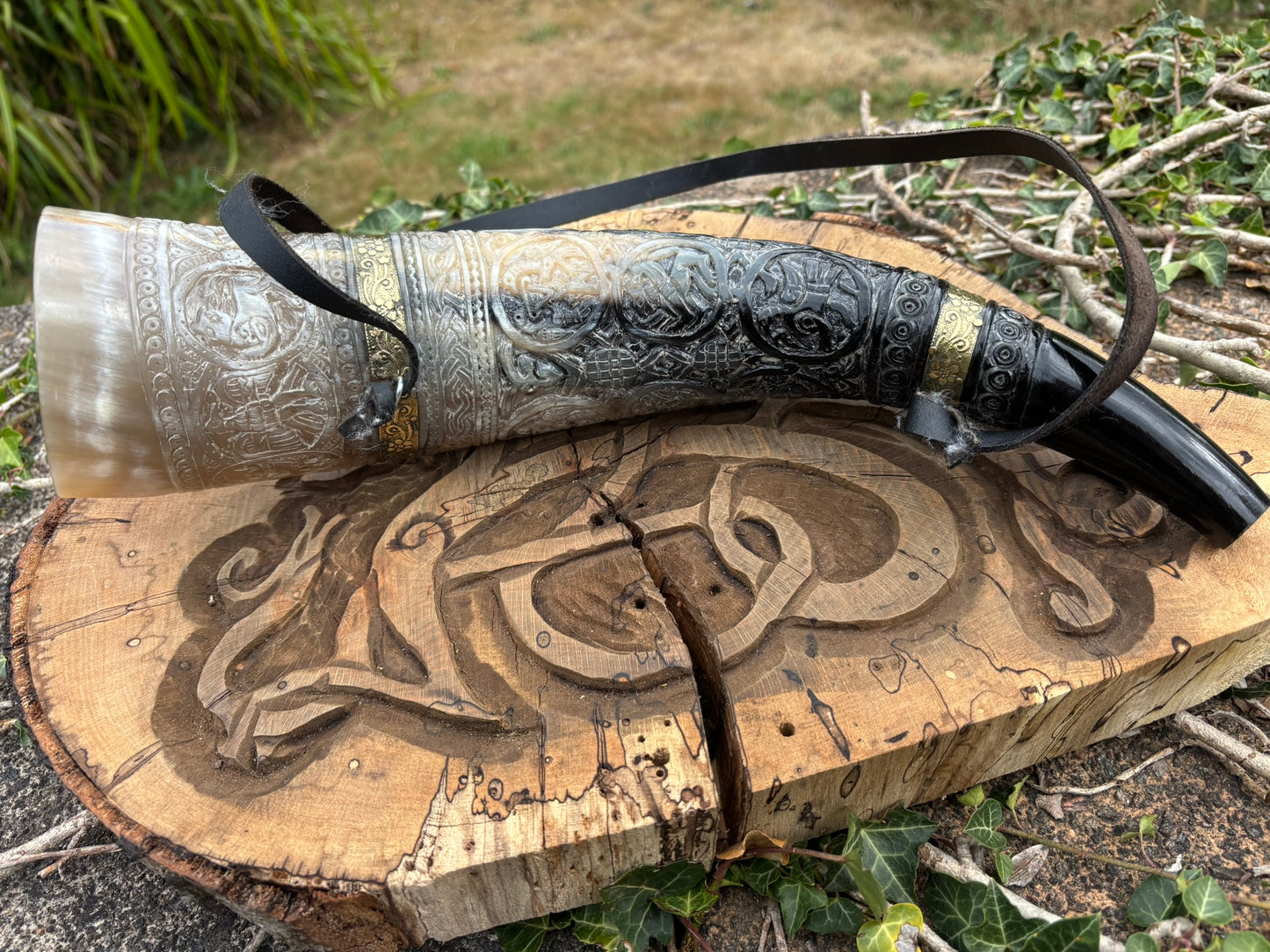 Viking blowing horn carved as a replica of the British Museum Oliphant, full length view from top side
