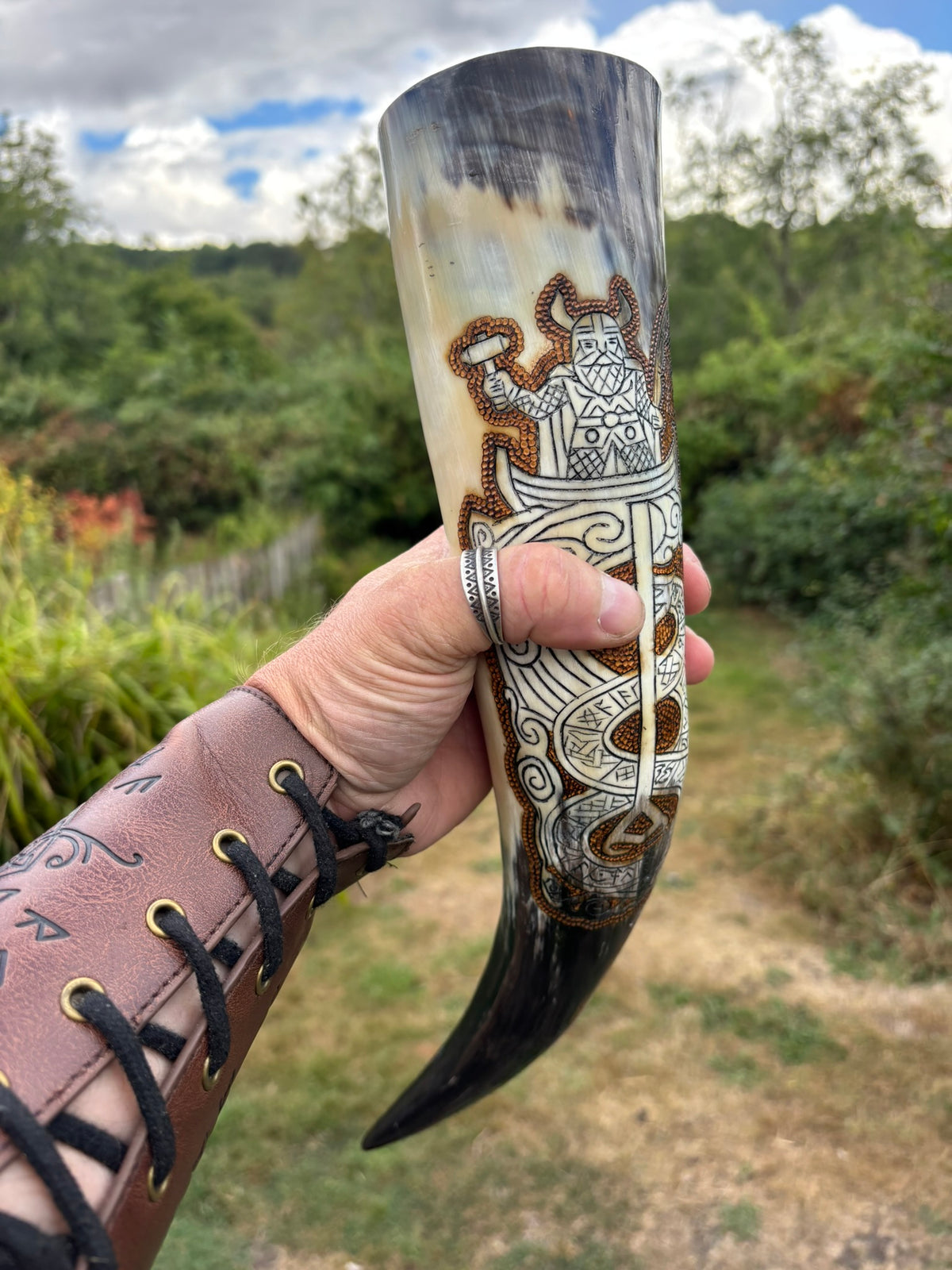 Thor Fishing for Jormungandr Viking Drinking Horn, featuring Norse-style engravings of a warrior and geometric patterns. The horn has a natural ivory to dark brown gradient with detailed silver and brown carvings.