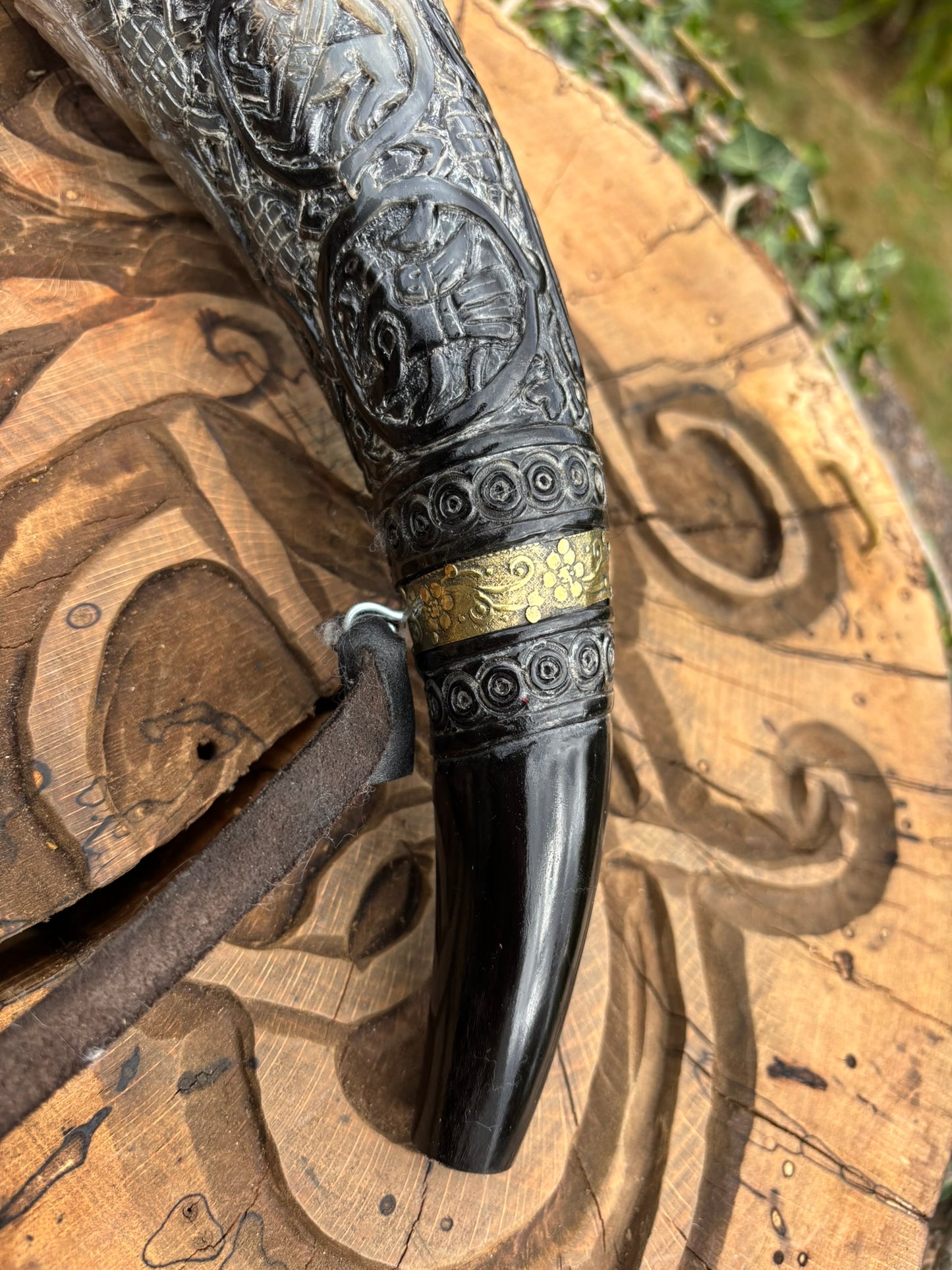 Close up of the bottom of the Viking horn showing Aperture and mouthpiece detail of ox horn Oliphant replica blowing horn
