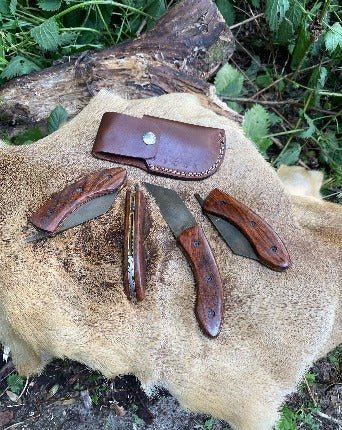 Comes with a leather pouch that attaches to a belt. Folding Seax Pocket Knife - Bushman Survival