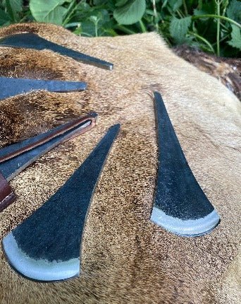 Kalahari Bush Axe - Bushman Survival, showing several axe heads on a reindeer hide